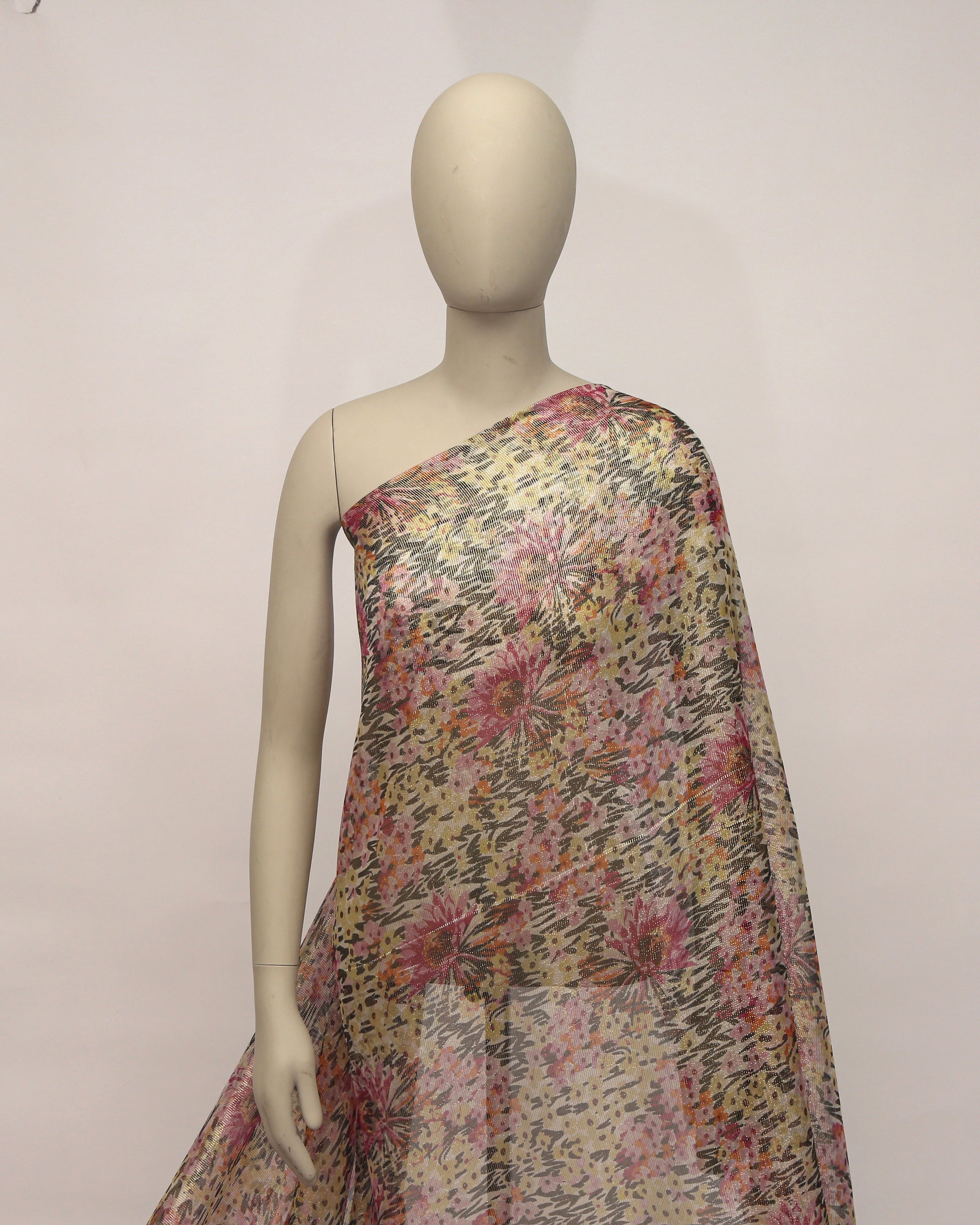 Floral patterned fabric with pink and yellow flowers on a beige background