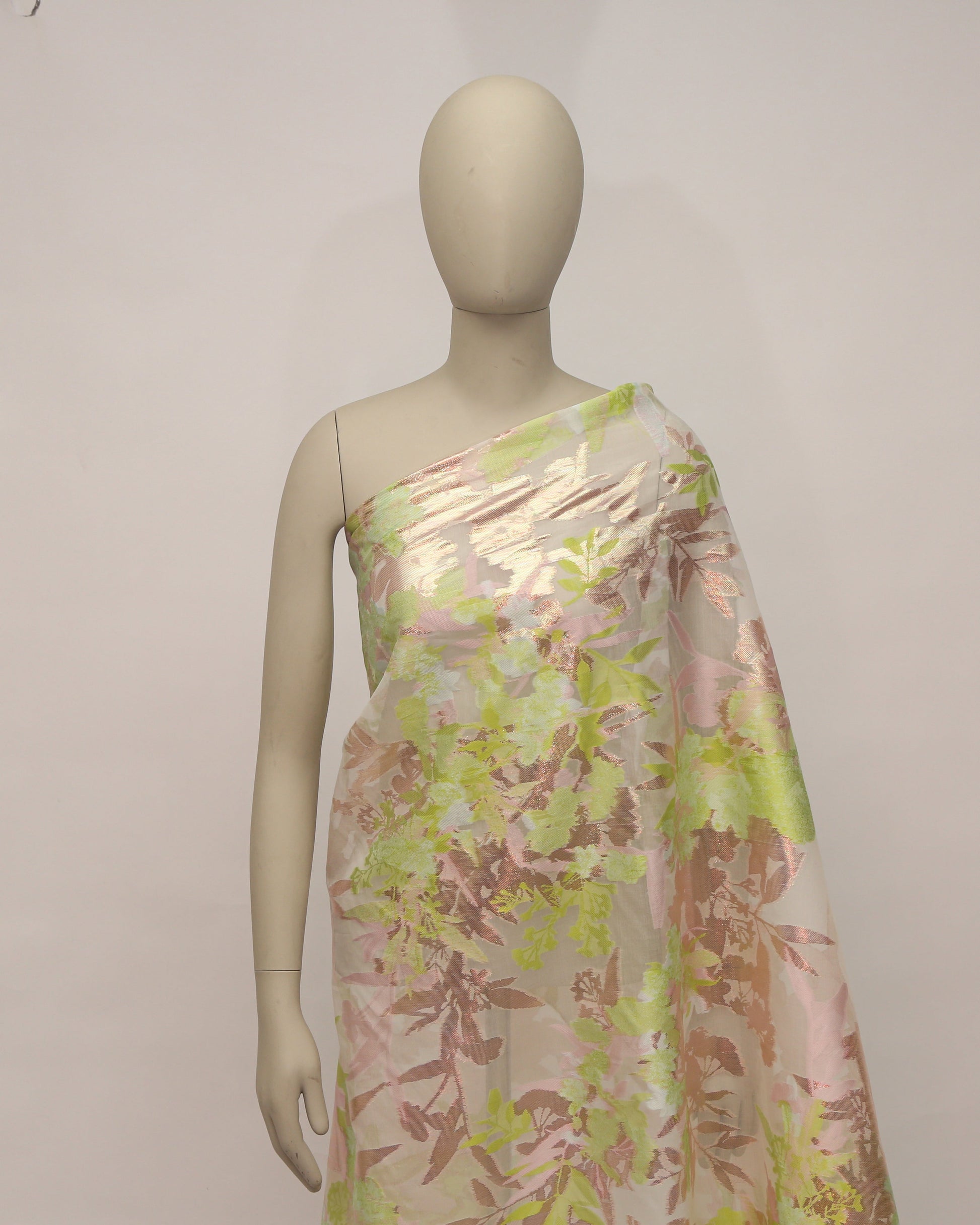 Mannequin wearing a floral one-shoulder dress against a plain background