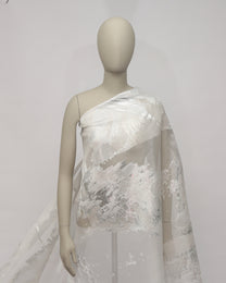 Mannequin wearing a white lace dress against a plain background