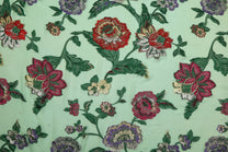 Floral embroidery pattern on a light green background