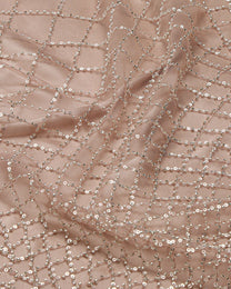 Close-up of brown fabric with silver sequin detailing