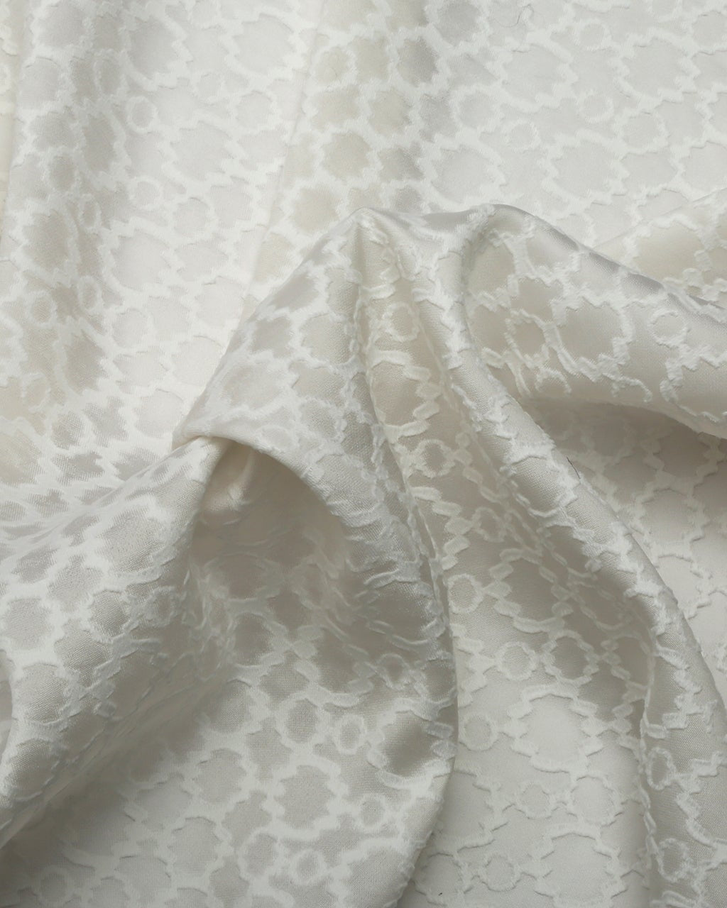 Close-up of white lace fabric with a subtle pattern