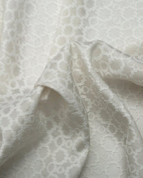 Close-up of white lace fabric with a subtle pattern